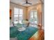 Well-lit dining room boasts a glass table, modern chairs, ceiling fan, and outdoor access at 638 Mcgruder Ne St, Atlanta, GA 30312