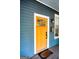 Close-up of a bright yellow front door with sidelight windows and a welcome mat at 638 Mcgruder Ne St, Atlanta, GA 30312
