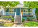 Charming blue home with a welcoming front porch, white railings, and landscaped yard at 638 Mcgruder Ne St, Atlanta, GA 30312