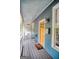 Inviting front porch with a cozy seating area, a yellow front door, and wood-paneled flooring at 638 Mcgruder Ne St, Atlanta, GA 30312