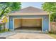 A two car garage, open to showcase the interior space, located in a lush green, tree-lined yard at 638 Mcgruder Ne St, Atlanta, GA 30312