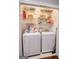 Compact laundry closet equipped with a washer, dryer, and organized shelving for storage at 638 Mcgruder Ne St, Atlanta, GA 30312