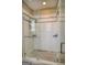 White tiled shower with black trim and glass door has mosaic tile floor and shower caddy at 638 Mcgruder Ne St, Atlanta, GA 30312