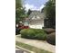 Home with a two-car garage, manicured shrubs, and a bay window on a quiet street at 1697 Preserve Park Dr, Loganville, GA 30052