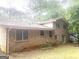 Back exterior of a brick house with a green lawn at 345 Fond Du Lac Dr, Stone Mountain, GA 30088