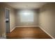 Bright dining room featuring hardwood floors, a chandelier, and a large window with mini blinds at 345 Fond Du Lac Dr, Stone Mountain, GA 30088