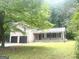 Brick home featuring a two-car garage and a welcoming covered porch, set on a large lot at 345 Fond Du Lac Dr, Stone Mountain, GA 30088