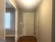 Hallway featuring hardwood floors, a white front door, with access to other rooms in the house at 345 Fond Du Lac Dr, Stone Mountain, GA 30088