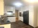 White kitchen featuring granite countertops, tiled backsplash, black appliances and hardwood floors at 345 Fond Du Lac Dr, Stone Mountain, GA 30088