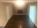 Spacious living room featuring hardwood floors, a brick fireplace, and neutral wall colors at 345 Fond Du Lac Dr, Stone Mountain, GA 30088