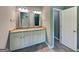 Bathroom vanity with double sinks, granite countertop, white cabinets and modern lighting at 3507 Hideaway Ln, Loganville, GA 30052