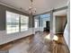 Elegant dining room featuring hardwood floors, wainscoting, and a stylish chandelier at 3507 Hideaway Ln, Loganville, GA 30052