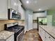 Modern kitchen with stainless steel appliances, granite countertops, and white cabinetry at 3507 Hideaway Ln, Loganville, GA 30052