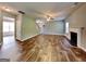 Open-concept living room featuring hardwood floors, a fireplace, and lots of natural light at 3507 Hideaway Ln, Loganville, GA 30052