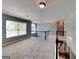 Spacious loft area with carpeting, large windows, and railing overlooking downstairs at 3507 Hideaway Ln, Loganville, GA 30052