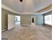 Spacious main bedroom with a tray ceiling, neutral carpet, and multiple entry doors at 3507 Hideaway Ln, Loganville, GA 30052