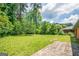 Spacious backyard with lush green grass and mature trees creating a serene outdoor space at 3219 W Manor Ln, Atlanta, GA 30311