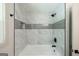 Tiled shower and bathtub in this remodeled bathroom featuring modern fixtures at 3219 W Manor Ln, Atlanta, GA 30311