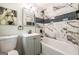 Modern bathroom with marble tile, updated fixtures, and a stylish vanity at 3219 W Manor Ln, Atlanta, GA 30311
