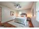 Cozy bedroom with hardwood floors, neutral walls, ceiling fan, and natural light at 3219 W Manor Ln, Atlanta, GA 30311