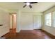 This bedroom has hardwood floors, a closet, and a ceiling fan at 3219 W Manor Ln, Atlanta, GA 30311