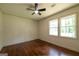 Bright bedroom featuring hardwood floors, a ceiling fan, and natural light from the windows at 3219 W Manor Ln, Atlanta, GA 30311