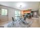 Stylish dining room features a modern glass table, contemporary chairs, and an open view to the kitchen at 3219 W Manor Ln, Atlanta, GA 30311