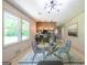 Bright dining area with a glass-top table, seating for four, and a view to the adjacent kitchen at 3219 W Manor Ln, Atlanta, GA 30311