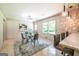 Dining room features a glass table with seating for four under a stylish light fixture, with a large area rug at 3219 W Manor Ln, Atlanta, GA 30311