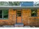 A rear entrance features brick steps, a door with glass panes, and ample natural light from nearby windows at 3219 W Manor Ln, Atlanta, GA 30311