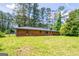 Brick house exterior, showcasing a well-maintained lawn and mature trees for a tranquil setting at 3219 W Manor Ln, Atlanta, GA 30311