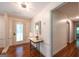 Inviting foyer with a decorative table, natural light, and hardwood floors at 3219 W Manor Ln, Atlanta, GA 30311