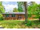 Charming brick home featuring a manicured lawn, stylish shutters, and inviting front entrance at 3219 W Manor Ln, Atlanta, GA 30311