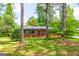 A spacious brick home with a long driveway and lush green lawn surrounded by mature trees at 3219 W Manor Ln, Atlanta, GA 30311