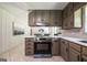 Updated kitchen featuring stainless steel appliances, eat-in counter, and plenty of cabinet space for storage at 3219 W Manor Ln, Atlanta, GA 30311