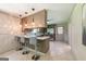 Kitchen with bar top seating, featuring pendant lighting and stainless steel appliances, creating an inviting space at 3219 W Manor Ln, Atlanta, GA 30311