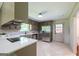 A spacious kitchen with updated stainless steel appliances and a door to the exterior, filled with natural light at 3219 W Manor Ln, Atlanta, GA 30311