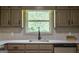 Kitchen sink features modern faucet with a large window and view, over looking the countertop at 3219 W Manor Ln, Atlanta, GA 30311