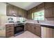 Modern kitchen with stainless steel appliances, ample cabinetry, and bright white countertops, with eat-in dining area at 3219 W Manor Ln, Atlanta, GA 30311