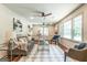 Bright living room boasts hardwood floors, a stylish gray sofa, a ceiling fan, and an area rug at 3219 W Manor Ln, Atlanta, GA 30311