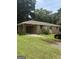 Brick home featuring a covered carport and a spacious front yard at 341 Boxwood St, Social Circle, GA 30025