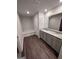 Bathroom with a double vanity, gray cabinets, granite countertop, and shower/tub combo at 116 Deer Xing, Temple, GA 30179