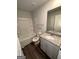 This bathroom is complete with a shower/tub combo, granite countertop, and white cabinets at 116 Deer Xing, Temple, GA 30179