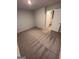 Empty bedroom with carpet and a white door at 116 Deer Xing, Temple, GA 30179