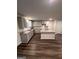 Spacious kitchen with gray cabinets, granite countertops, a center island, and modern flooring at 116 Deer Xing, Temple, GA 30179
