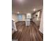 Open-concept kitchen with a center island, gray cabinets, and stainless steel appliances at 116 Deer Xing, Temple, GA 30179