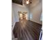 Open-concept living space with hardwood floors, vaulted ceiling with fan, and kitchen view at 116 Deer Xing, Temple, GA 30179