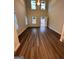 Bright living room featuring hardwood floors, large windows, and a vaulted ceiling with a ceiling fan at 116 Deer Xing, Temple, GA 30179