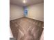 This carpeted bedroom features neutral walls and a window at 116 Deer Xing, Temple, GA 30179