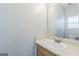 Neutral bathroom with a single sink, a large mirror, and bright lighting at 2635 Carolina Rdg, Riverdale, GA 30296